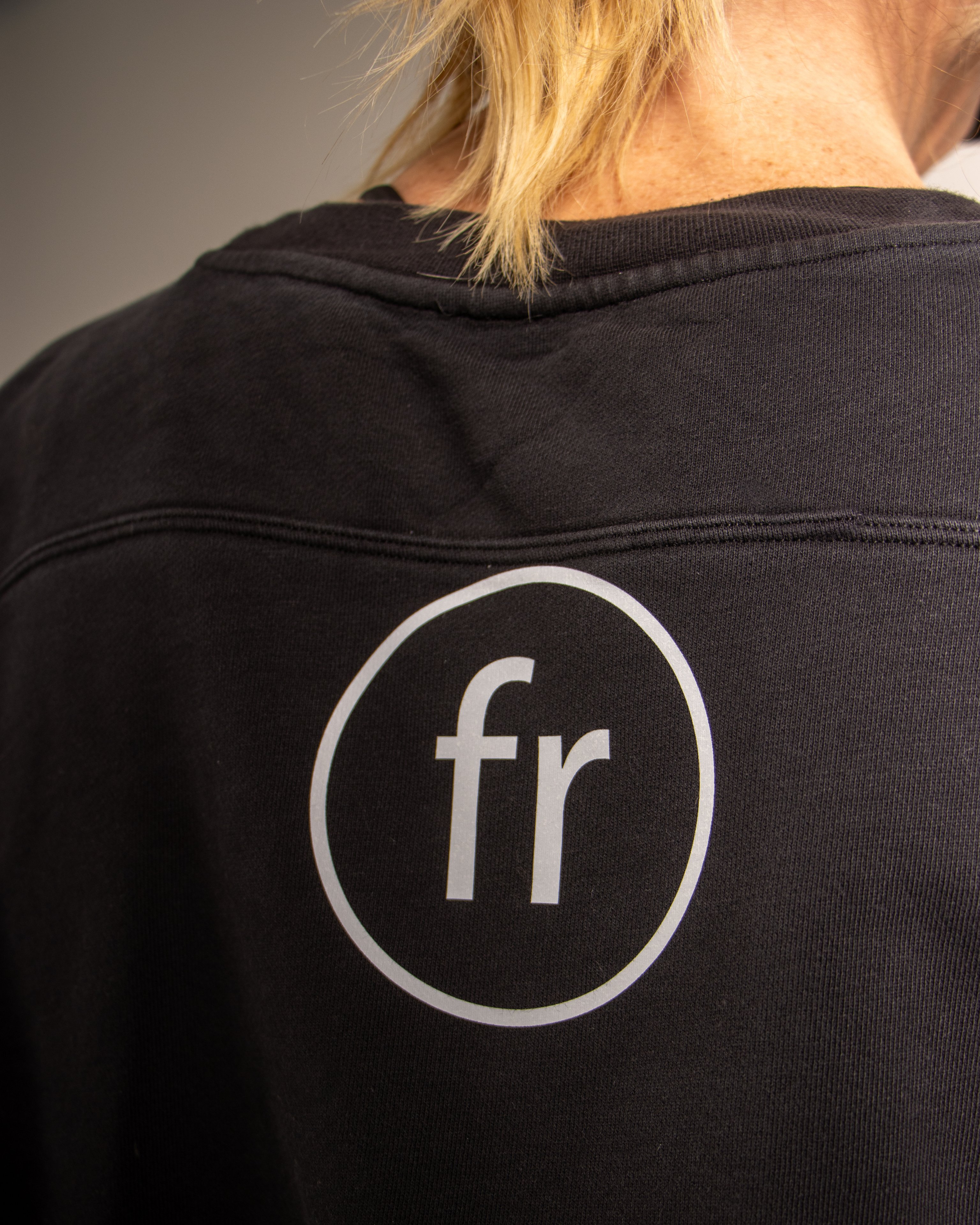 The Fiona Rooney mark on the back of a black training shirt