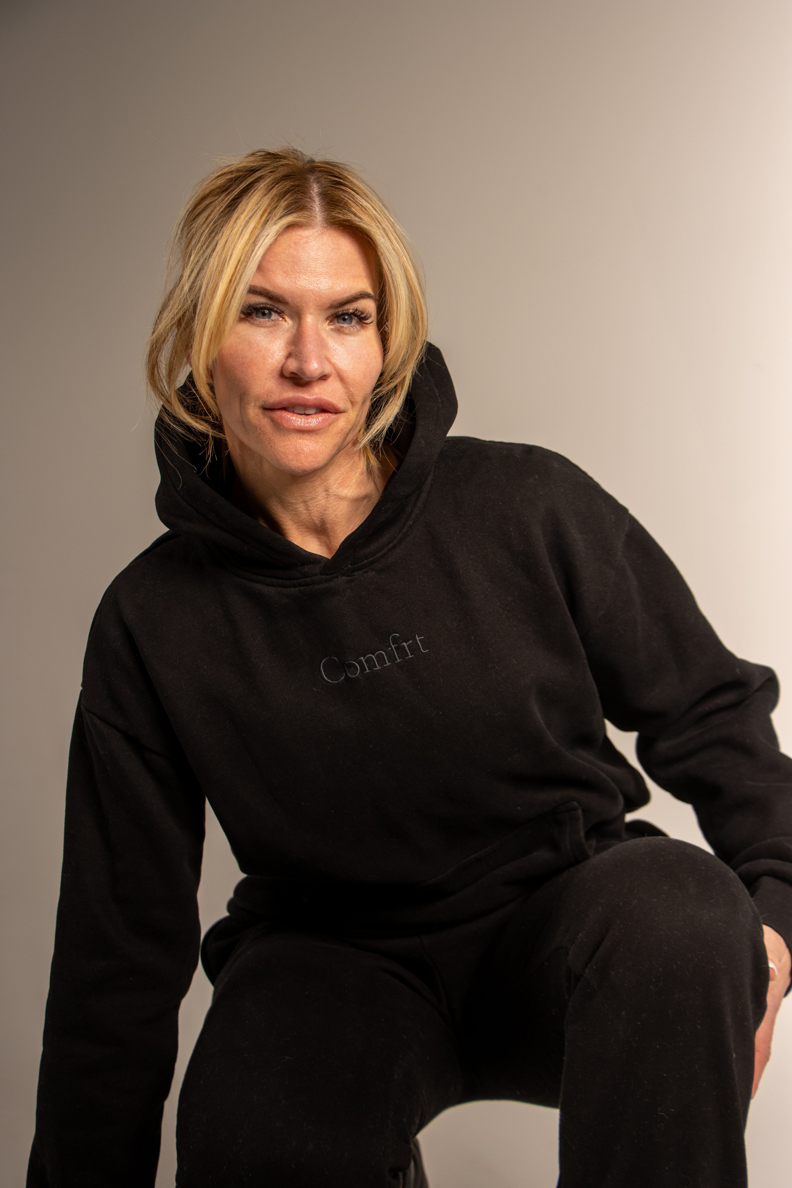 Fiona Rooney studio portrait in a black hoodie
