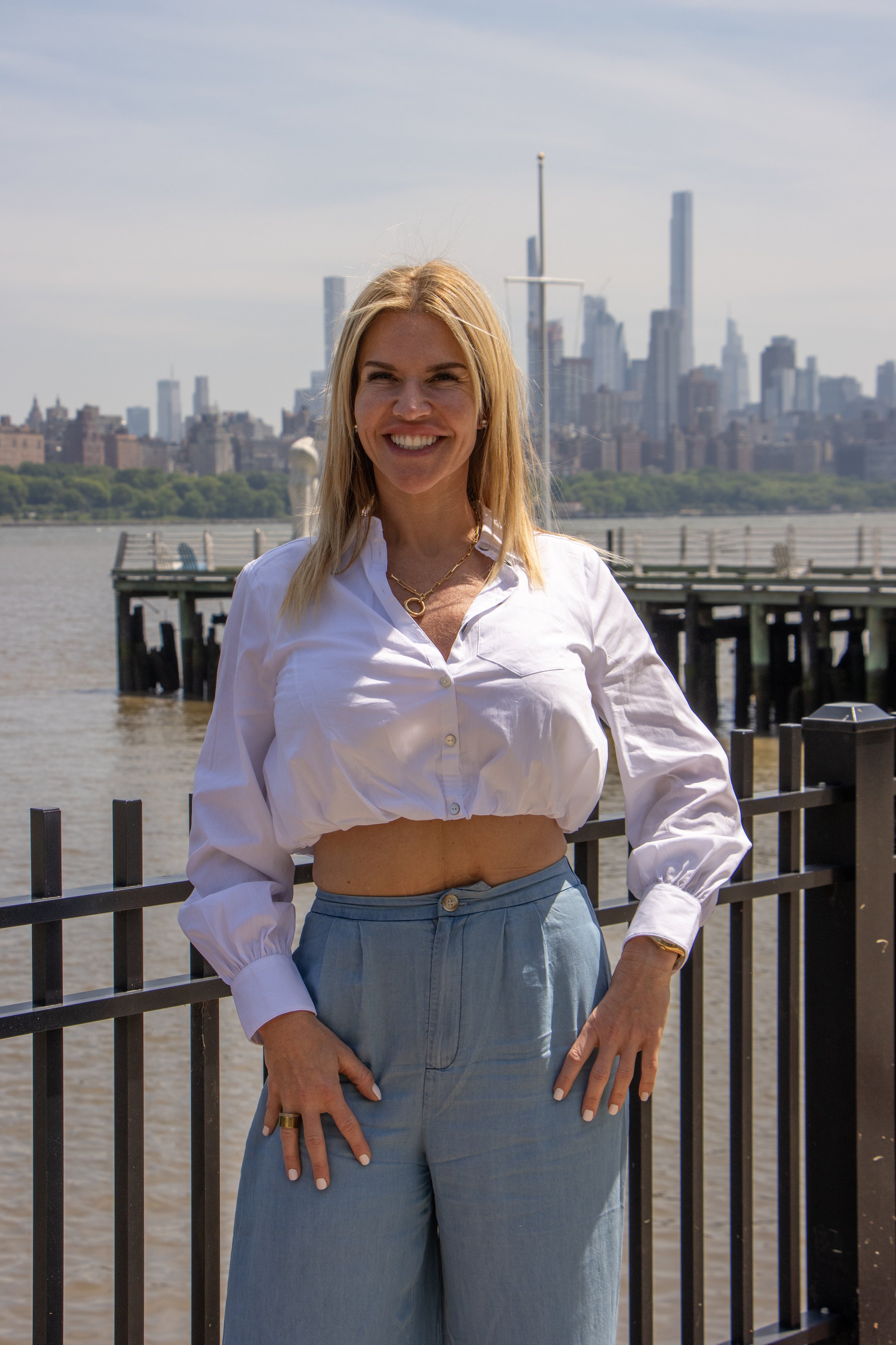 Fiona Rooney at the waterfront with the city skyline behind her