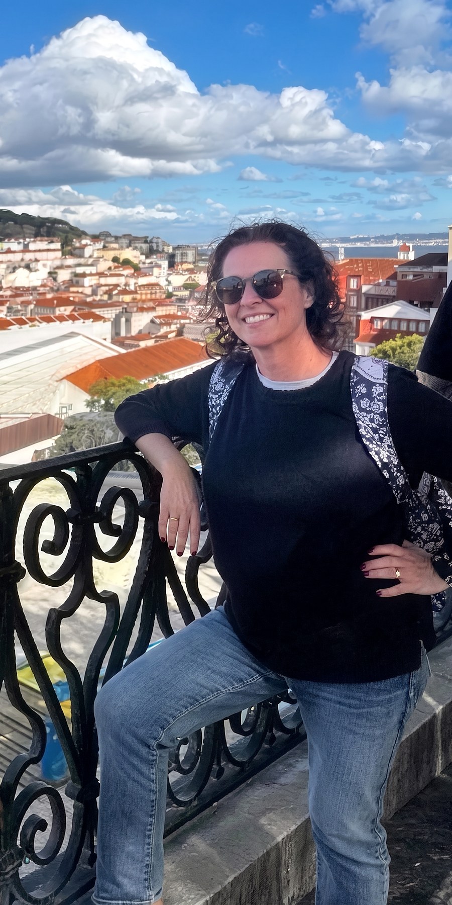 After, leaning on a balcony rail above a city